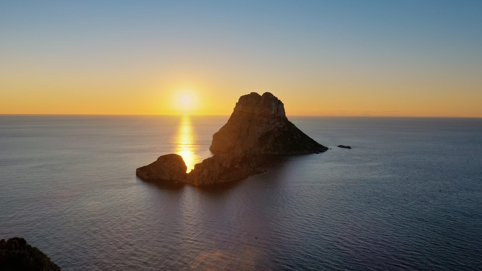 Es Vedrà — the iconic sea stack at sunset, viewed from Cala d'Hort