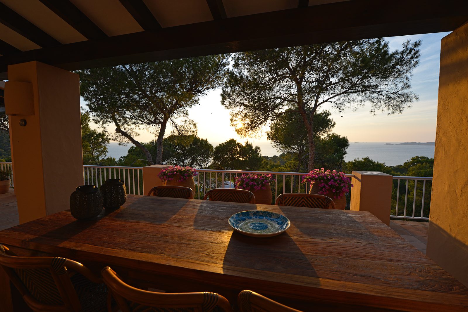 Can Beteigeuze terrace at golden hour with wine glasses and sea view